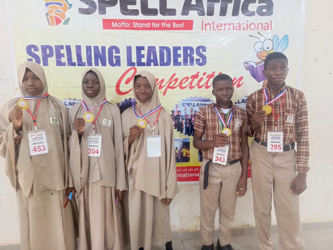 A student receiving a spelling competition award